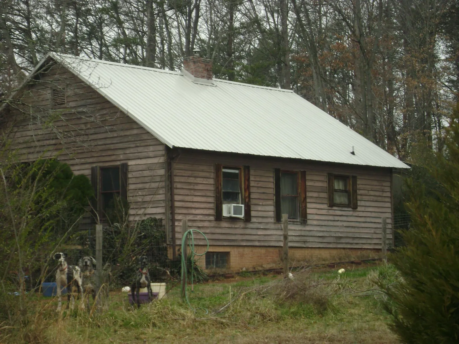 White metal roof on an old wood sided farmhouse, from a Metal Roof Installation job in Penn Run